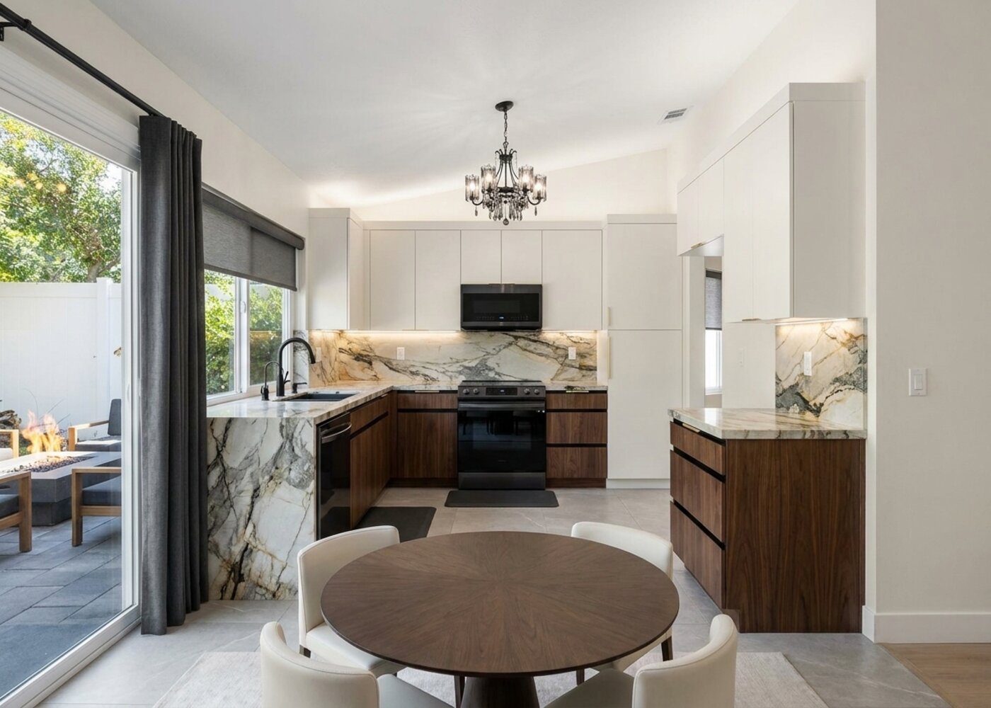 Murrieta kitchen after remodel with marble island and view to backyard, designed by Michael Alex